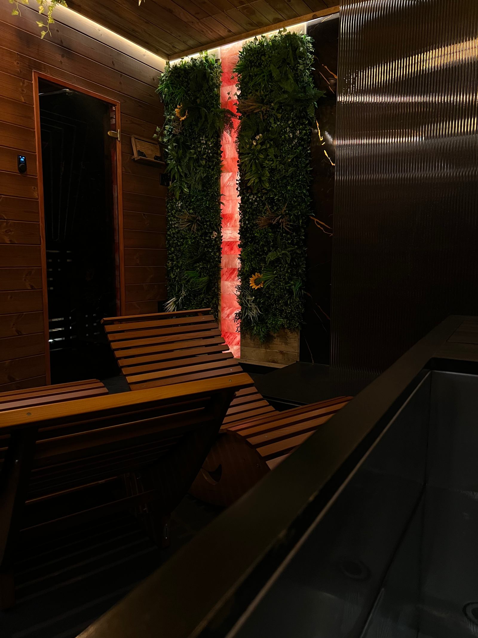 Sauna seating and a softly lit feature wall inside The Forge.