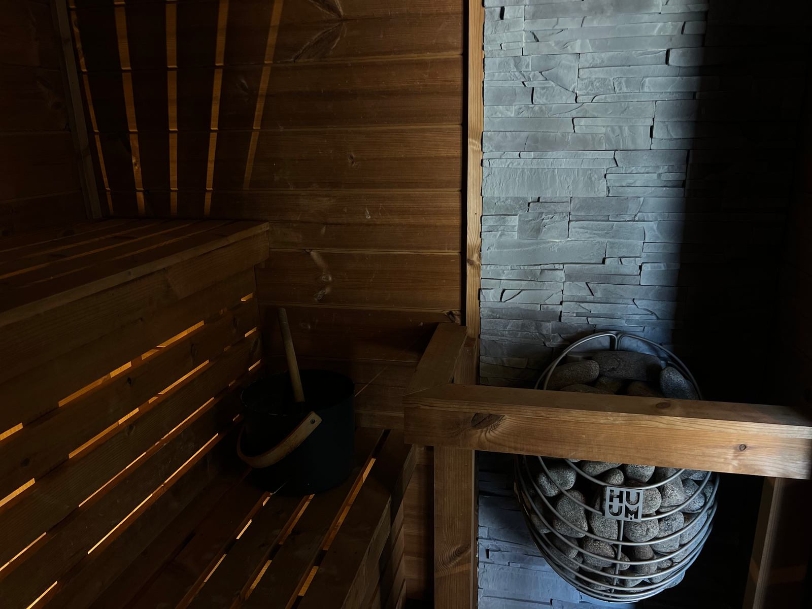 Timber benches and the sauna heater in The Forge.
