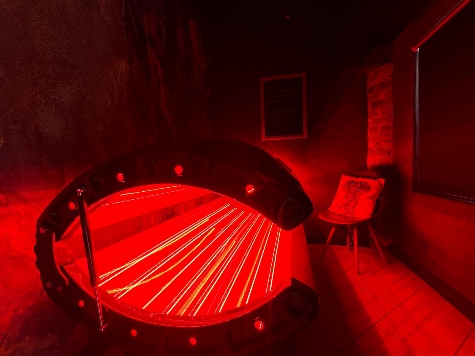 The red-light therapy bed in its private treatment space.