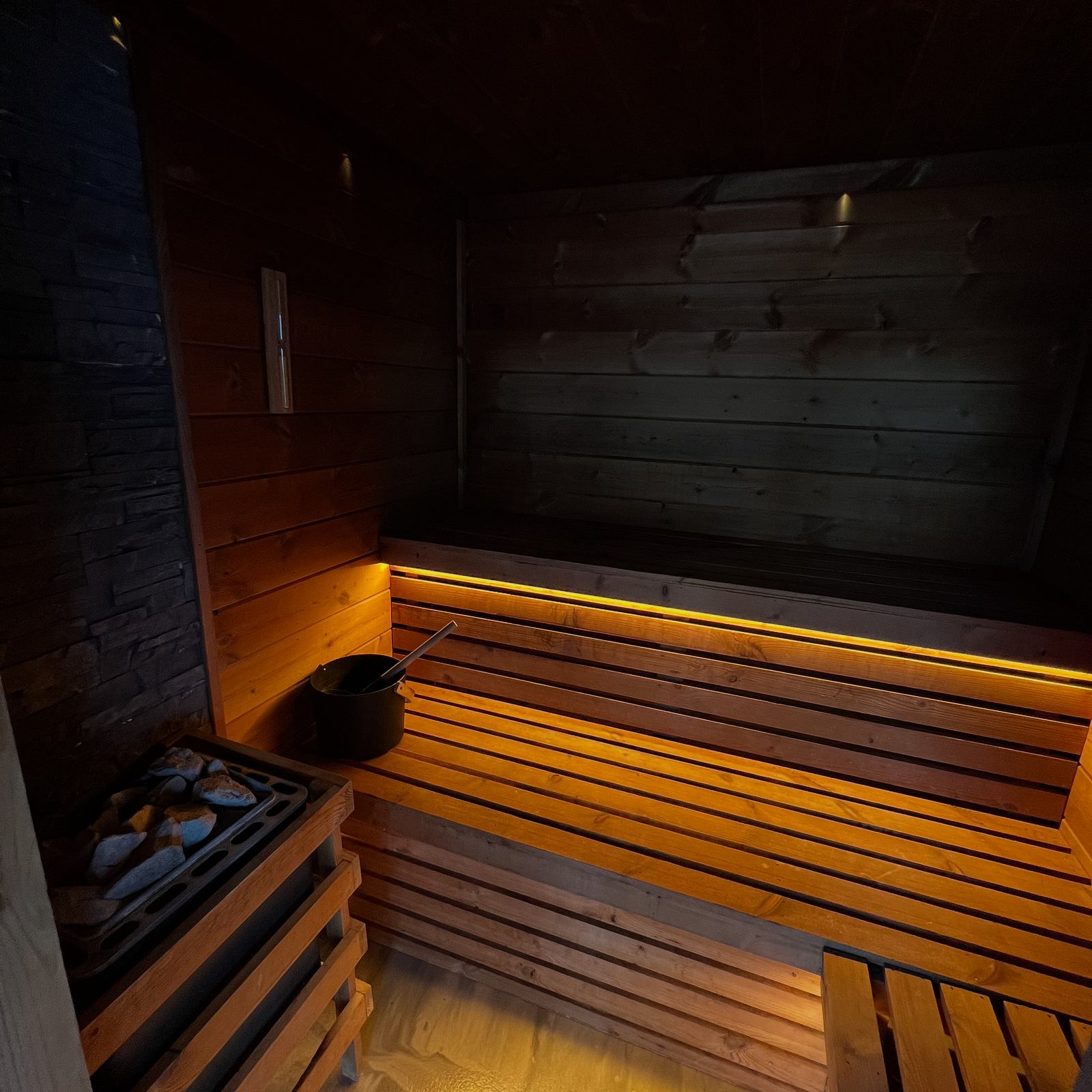 Warm timber seating inside the Serenity Room sauna.